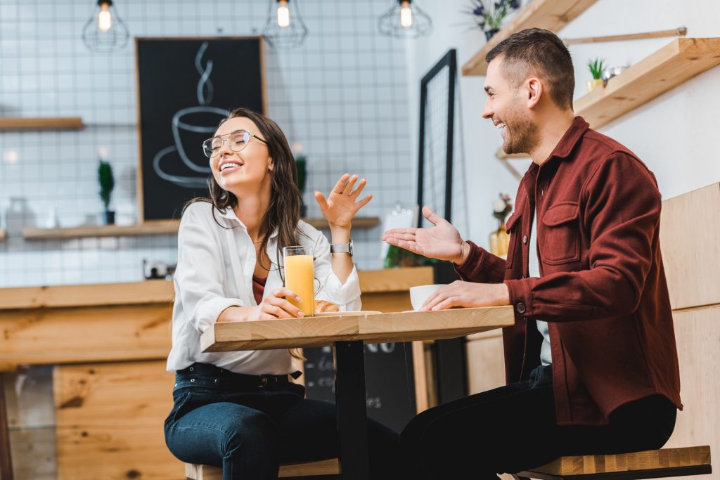 man and woman laughing and having lots of fun on a date