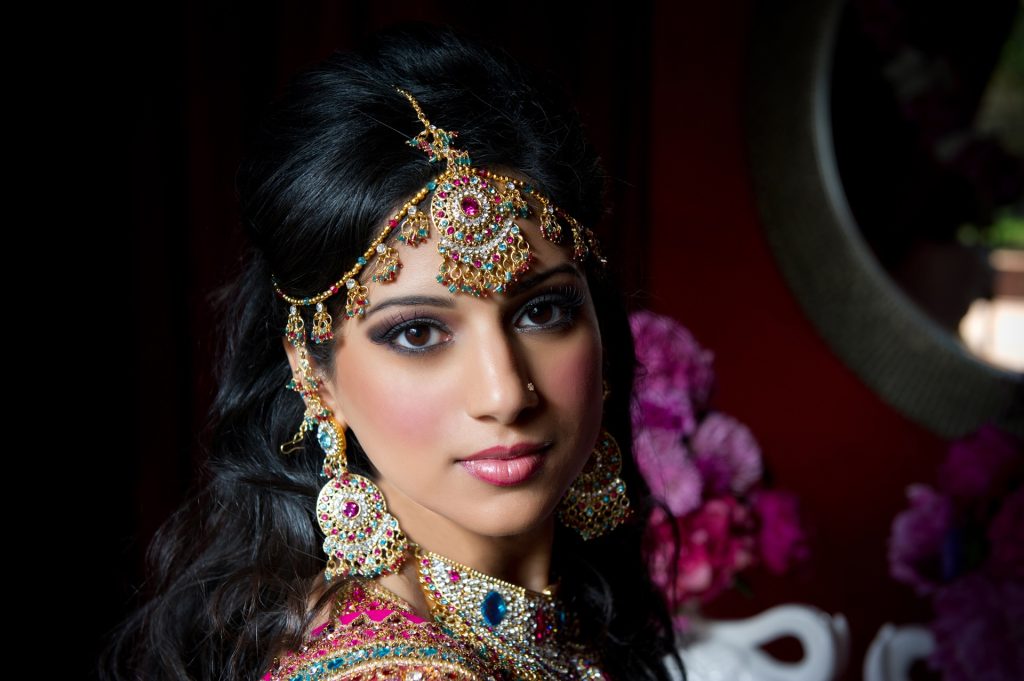gorgeous Indian bride in traditional dress remembering about dating, seduction and flirting with men in India