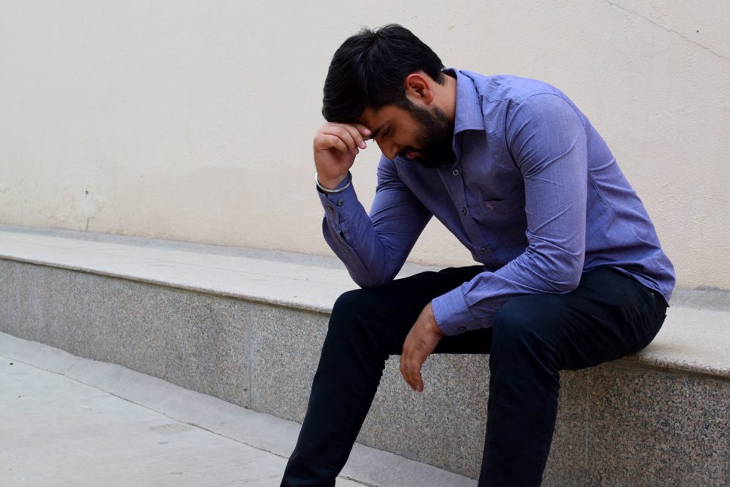 sad, bearded Indian man thinking about all the problems with seduction and dating in India with Hindu women and girls